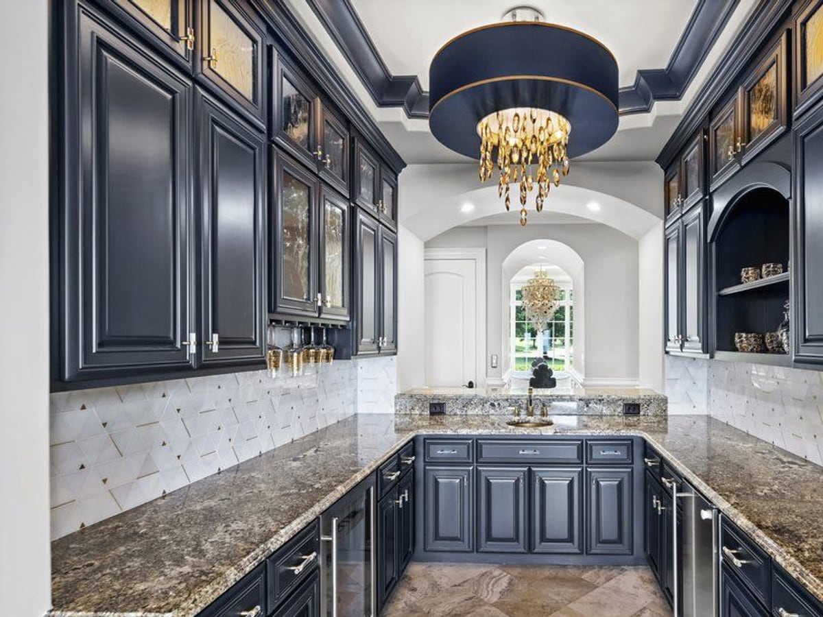 A navy butler’s pantry, refinished rich by Carolina Superior Painting LLC, Clayton